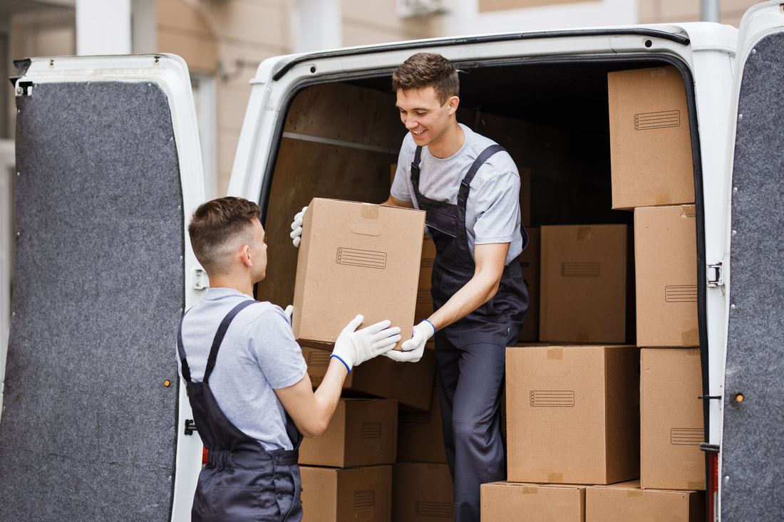 Two removal workers loading boxes into a van during a Nottingham removal Two removal workers loading boxes into a van during a Nottingham removal